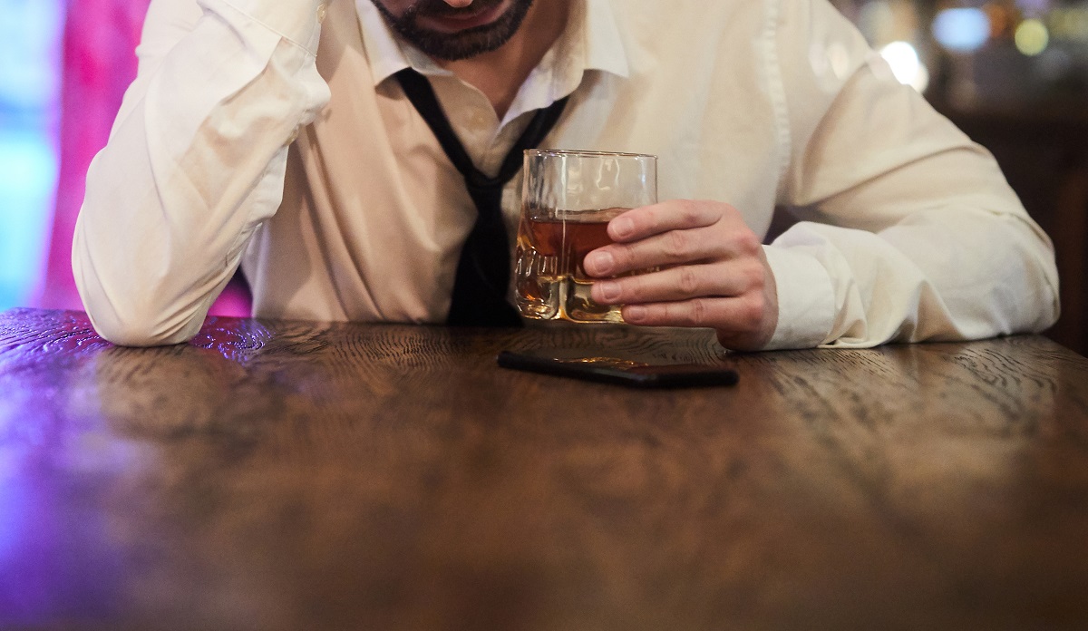 Depressed Man Drinking in Bar